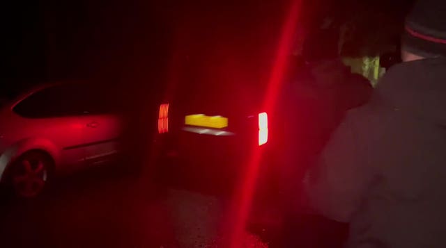 A car believed to be carrying Andrew Mountbatten-Windsor arrives at the Sandringham Estate in Norfolk in the dark