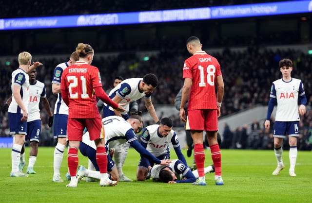 Rodrigo Bentancur is checked on by team-mates as he lies on the ground