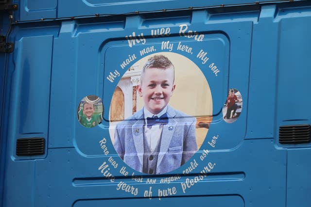 Images on the back of a haulage lorry that carried the coffin of Ronan Wilson