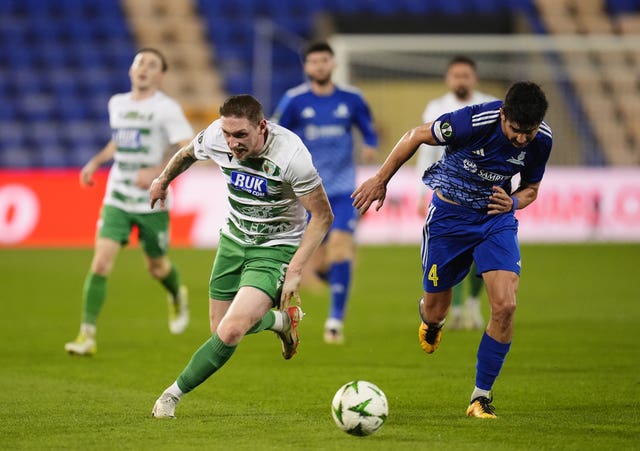 Declan McManus runs for the ball against an Astana player