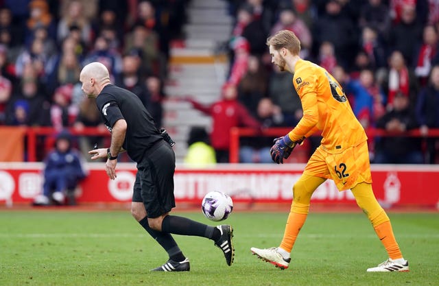 Referee Paul Tierney allows play to restart with Liverpool goalkeeper Caoimhin Kelleher