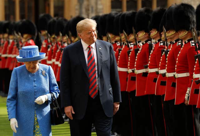 Donald Trump and the late Queen Elizabeth II inspect a guard of honour at Windsor Castle 