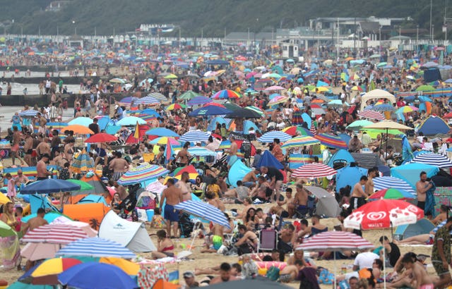 People enjoy the hot weather at Bournemouth beach in Dorset 