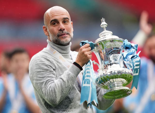 Manchester City manager Pep Guardiola celebrates with the FA Cup trophy