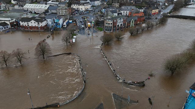 View from above of a river which has burst its banks and flooded nearby streets