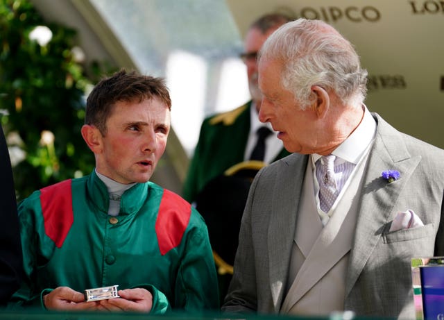 King Charles III speaks to jockey Chris Hayes 