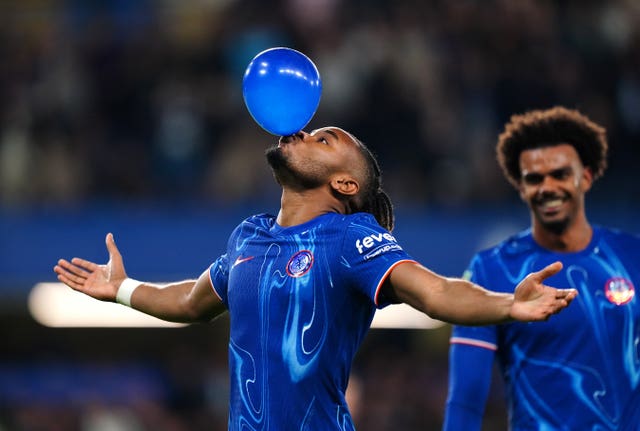 Christopher Nkunku blows up a balloon to celebrate scoring a hat-trick in Chelsea''s win over Barrow