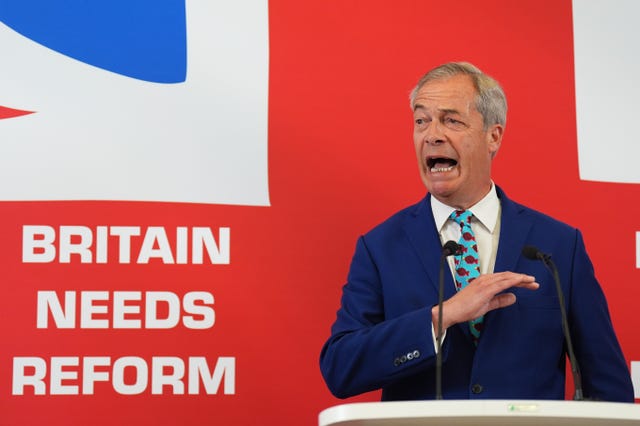 Nigel Farage speaking at a press conference in front of a Union Jack backdrop