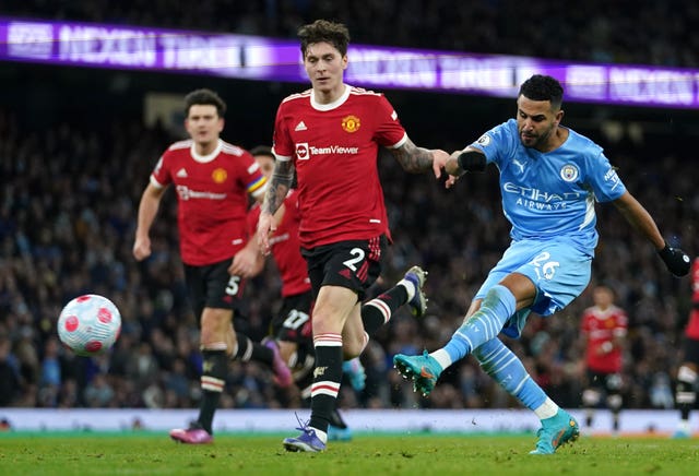 Manchester City forward Riyad Mahrez scores against Manchester United