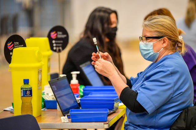 Healthcare workers administering vaccine