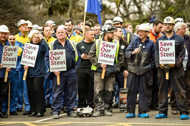 A group of workers holding placards reading 'Save our steel'