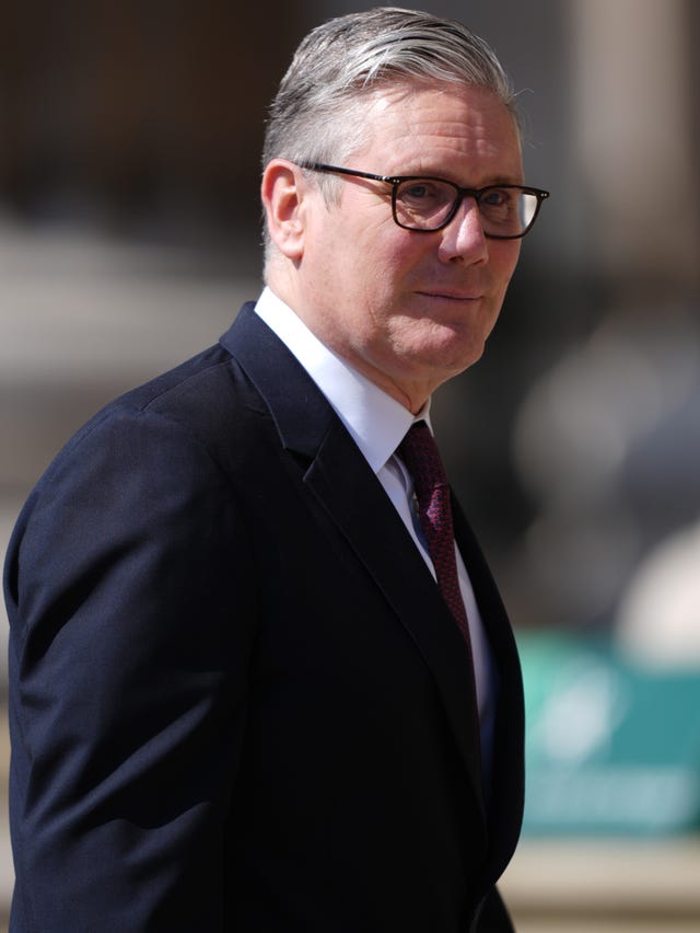 Sir Keir Starmer smiling while walking outside