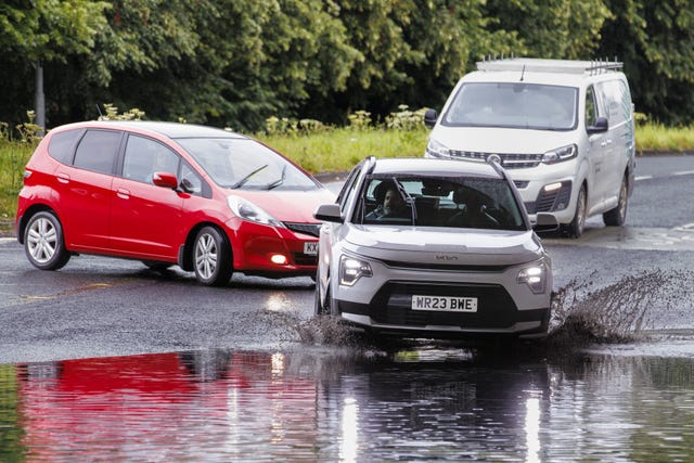 Vehicles navigate flooding in Belfast