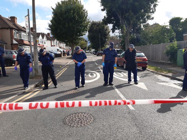 Lines of officers on Brocks Drive in North Cheam, as they carried out fingertip searches behind a cordon 