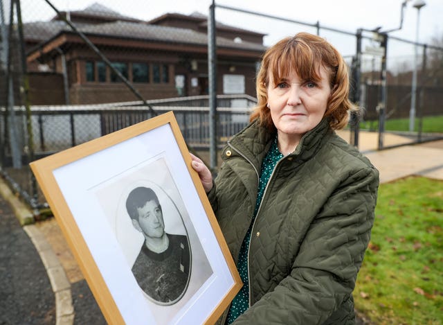 Kevin McKearney's widow Bernie McKearney holding a framed photo