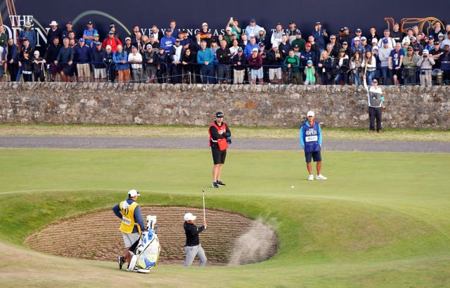 Xander Schauffele blasts out of a bunker 