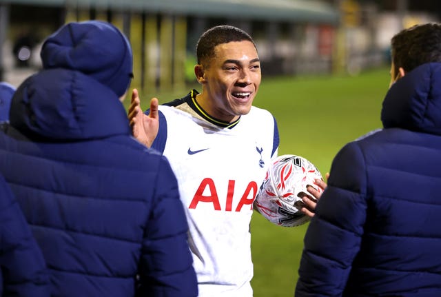 Tottenham striker Carlos Vinicius celebrates with the match ball after scoring a hat-trick at Marine