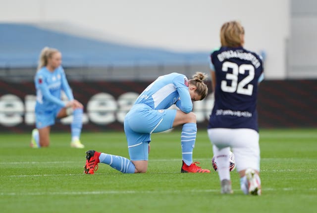 City’s Ellen White (centre) taking a knee prior to the match against West Ham earlier this month (Zac Goodwin/PA).