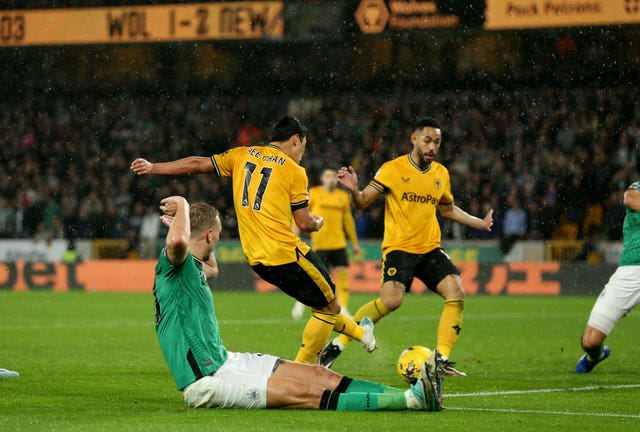 Hwang Hee-chan, second left, scores Wolves' second goal