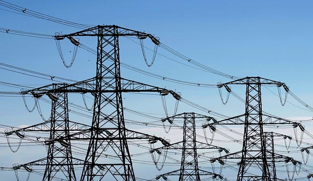 File photo dated 26/08/2022 of electricity pylons run across Romney Marsh in Kent from Dungeness nuclear power station