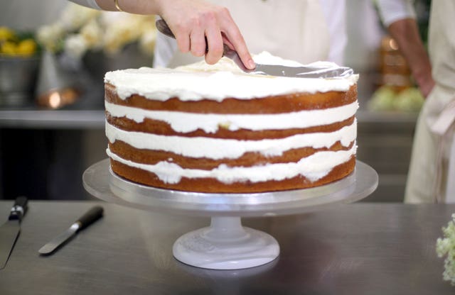 Work proceeds on the cake for Harry and Meghan's big day (Hannah McKay/PA)