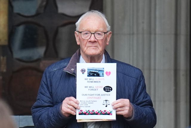 Barry Laycock holding a placard outside court