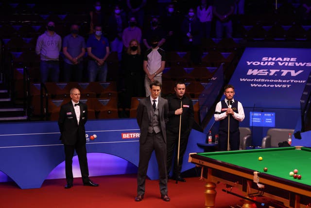 Presenter Rob Walker, Stephen Maguire, Jamie Jones and spectators observed a minute's silence at the Crucible