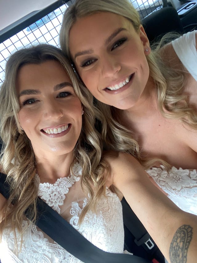 Brides in the back of a police car