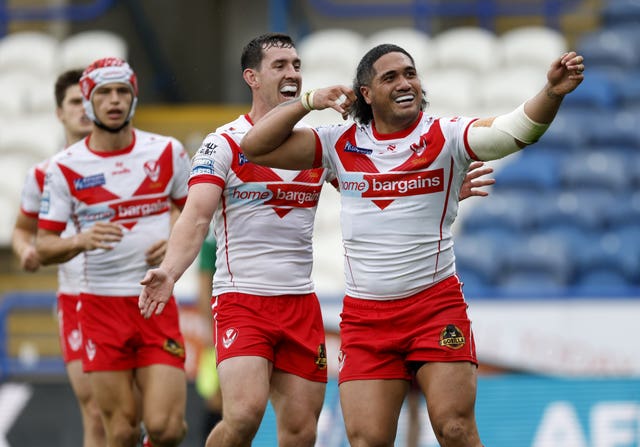 St Helens’ Sione Mata’Utia, right, celebrates after scoring a try against Super League rivals Huddersfield