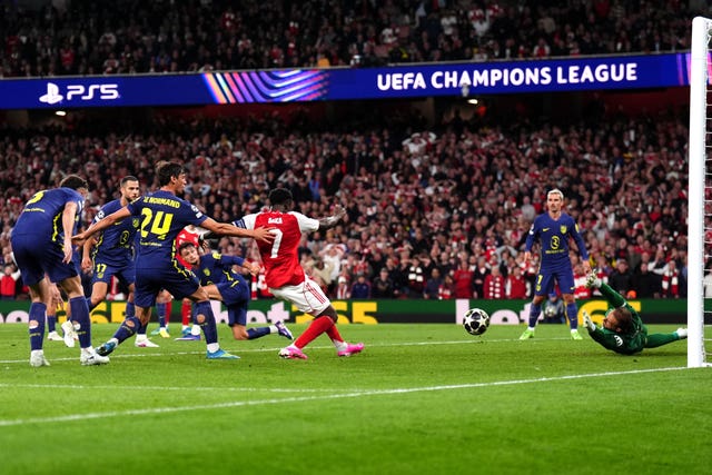 Bukayo Saka, centre, gives Arsenal the lead against Atletico Madrid