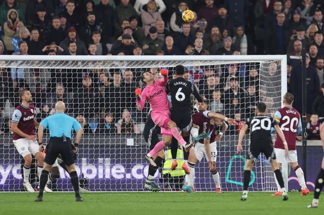 Lukasz Fabianski attempts to punch the ball clear but concedes a penalty for a foul on Gabriel