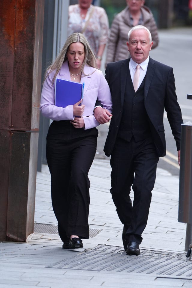 Rebecca Joynes arm-in-arm with a man walking beside her