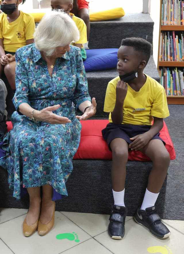 The Duchess of Cornwall speaks to a student using sign language