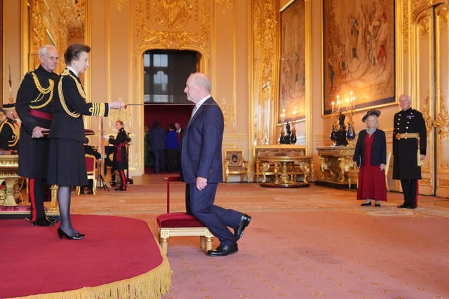 Sir Alan Bates being knighted by the Princess Royal