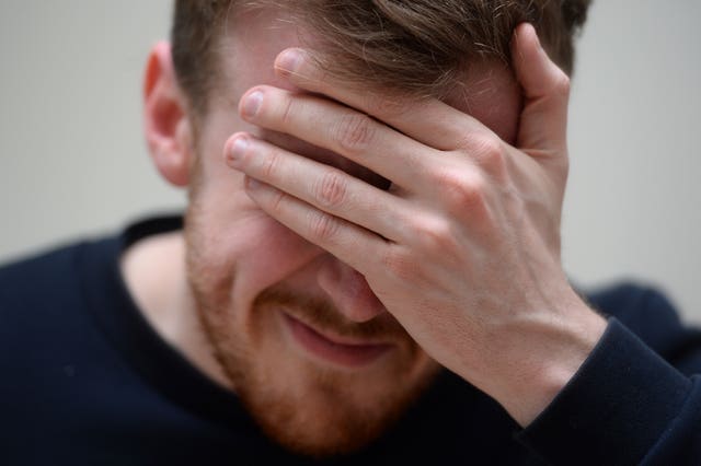 A man showing signs of pain from a headache (Kirsty O’Connor/PA)