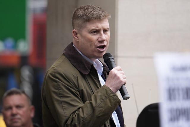 Eddie Dempsey speaking into a microphone