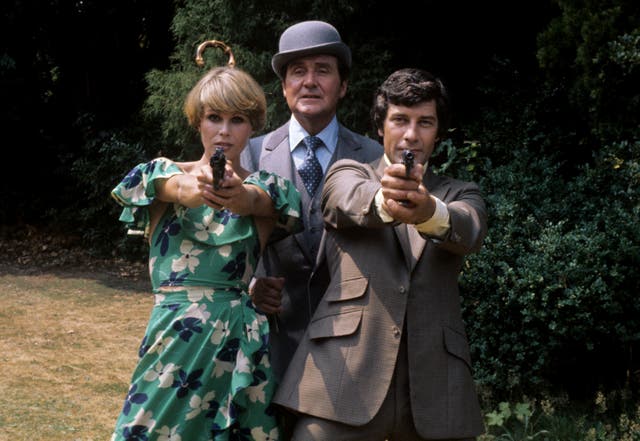 Joanna Lumley, who plays Purdey, Patrick MacNee, who plays John Steed, and Gareth Hunt, who plays Mike Gambit, pictured during filming at Pinewood Studios