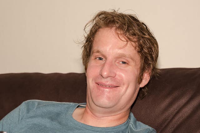 Andrew Bagshaw leans against a sofa
