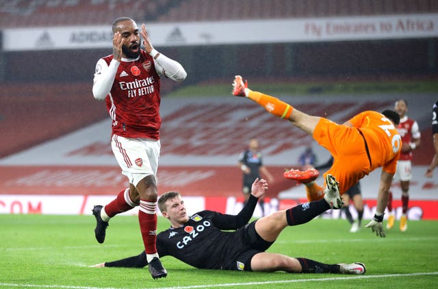 Villa's Matt Targett and goalkeeper Emiliano Martinez combine to frustrate Alexandre Lacazette, left