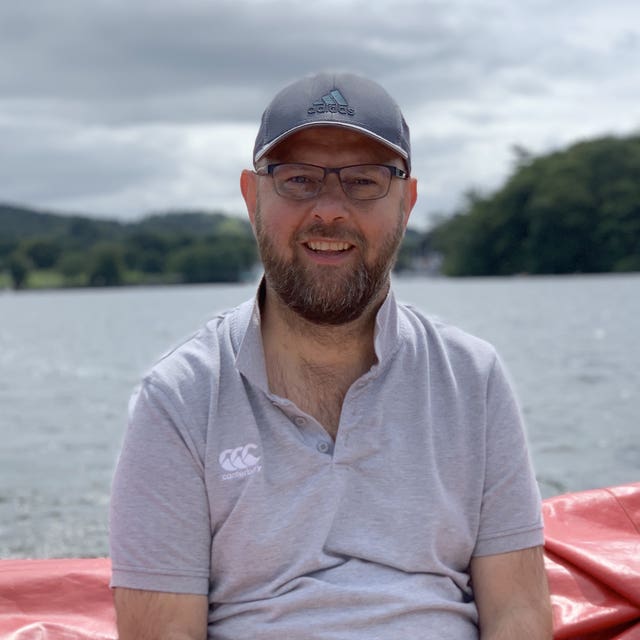 Handout photo of Andrew Slorance smiling in front of water