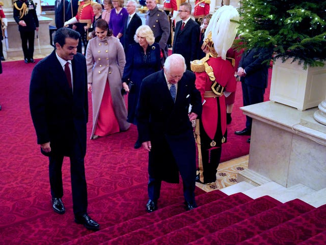 The King and Queen walk with the Emir of Qatar Sheikh Tamim bin Hamad Al Thani and his wife Sheikha Jawaher, at Buckingham Palace (Jonathan Brady/PA)