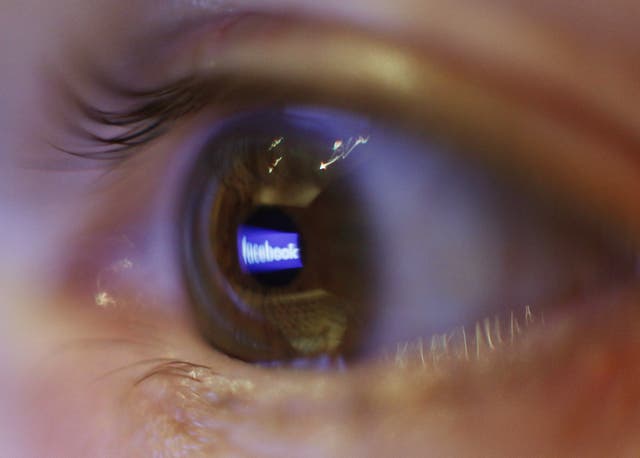 The Facebook logo reflected in an eye