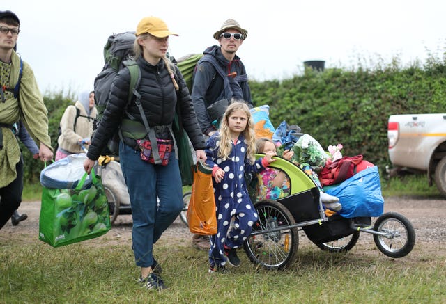 People arrive on the first day of the Glastonbury Festival at Worthy Farm in Somerset