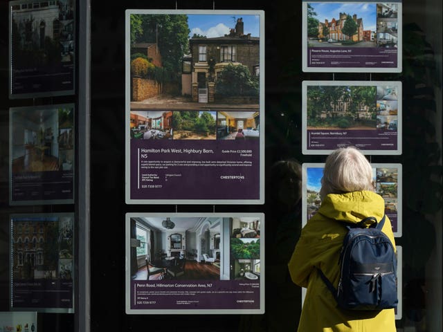 Woman looking at estate agent window