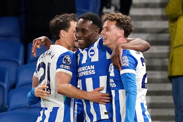 Danny Welbeck (centre) celebrates with team-mates after scoring Brighton's third goal