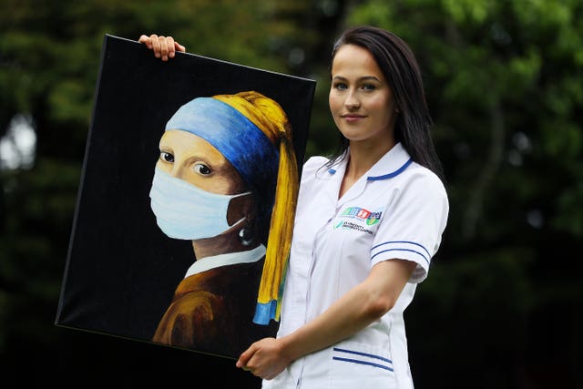 Chloe Slevin with a previous painting, Girl With A Surgical Mask