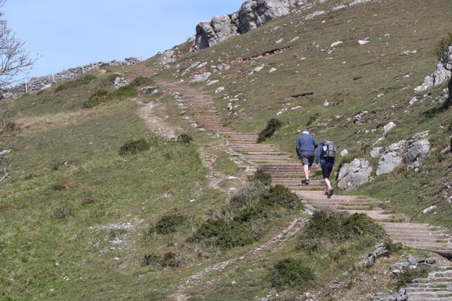 People walk up the Great Orme in Llandudno, Wales, where lockdown restrictions have eased 