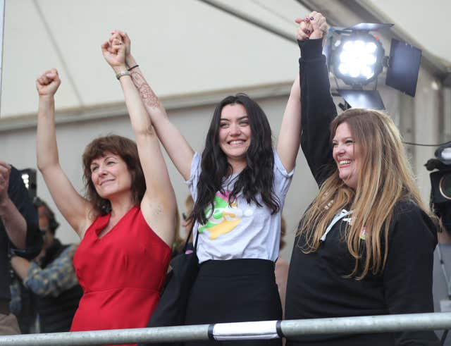 Campaigners Tara Flynn, Lucy Watmough and Roisin Ingle celebrate in Dublin Castle (Niall Carson/PA)