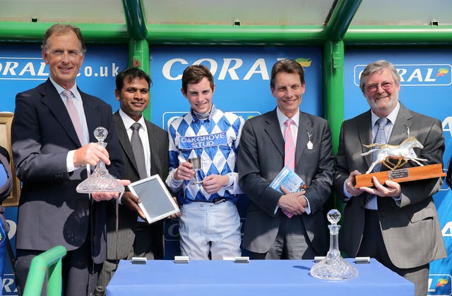 Owner John Deer (right), jockey James Doyle (centre) and trainer Roger Charlton (left) celebrate winning the Coral-Eclipse with Al Kazeem 