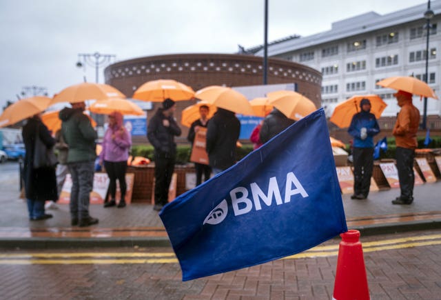 Resident doctors on a picket line, with a BMA flag in the foreground